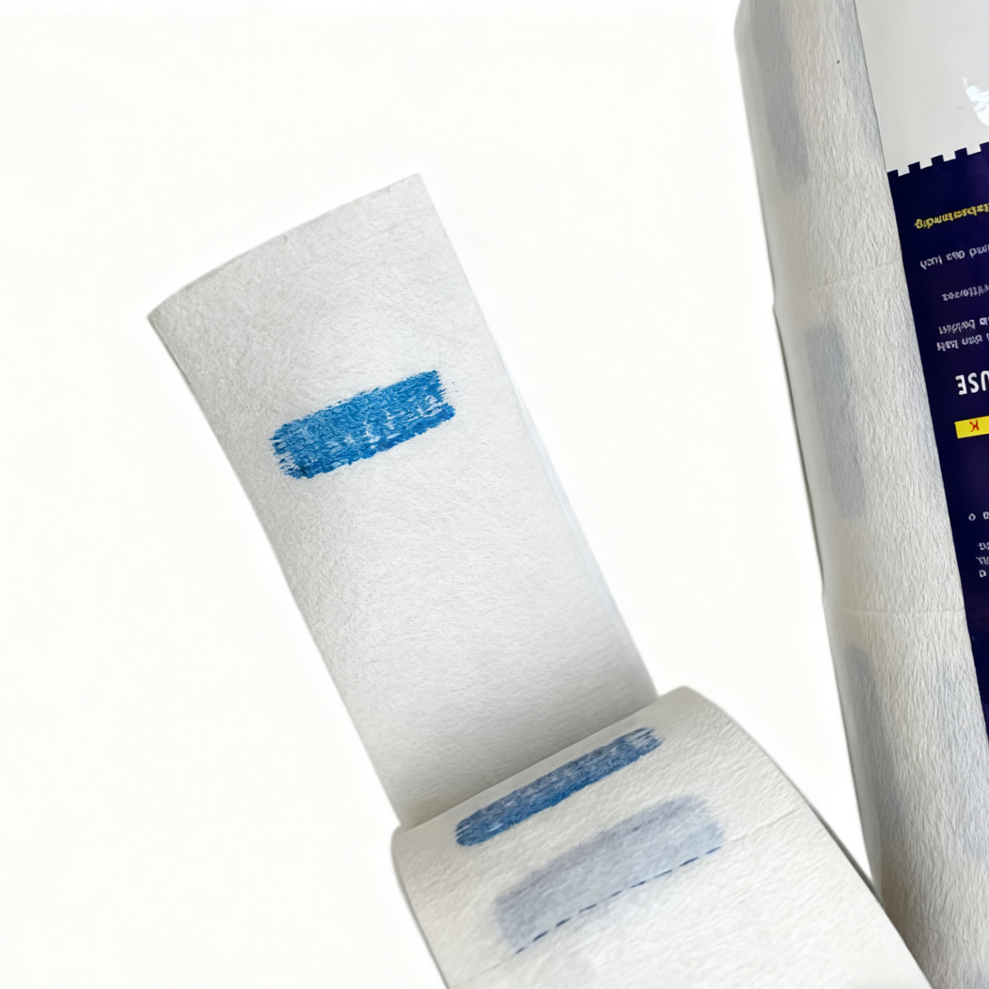 BeautéSync® Barber Neck Paper detail close-up showing disposable neck ruffle texture, perforated tear lines, and roll core design, 6.5cm width, 10.5cm diameter