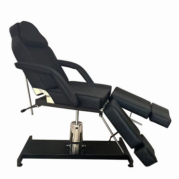 Hydraulic tattoo chair with adjustable positioning for artists and clients. Side view.