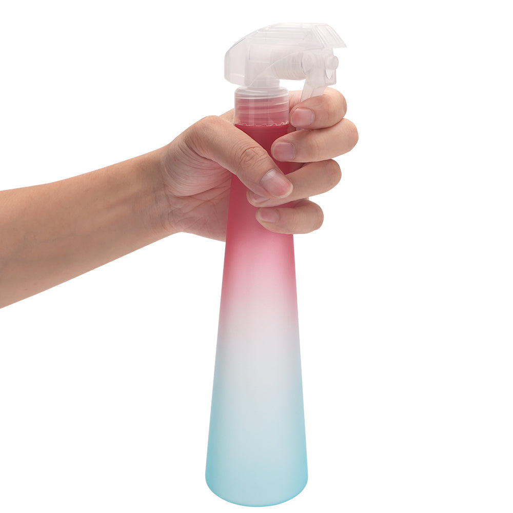 rainbow hair spray bottle pink and green being used