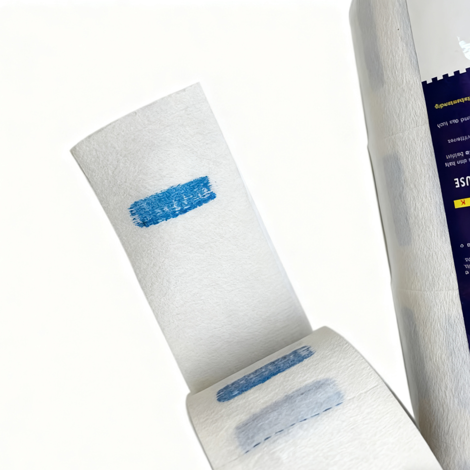 BeautéSync® Barber Neck Paper detail close-up showing disposable neck ruffle texture, perforated tear lines, and roll core design, 6.5cm width, 10.5cm diameter
