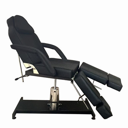 Hydraulic tattoo chair with adjustable positioning for artists and clients. Side view.